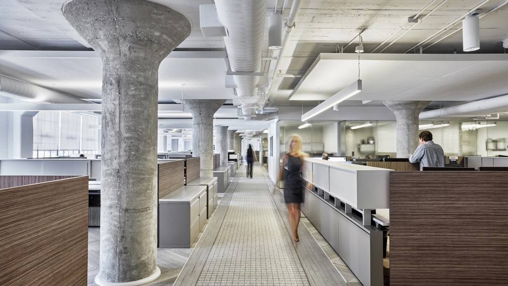 A person in a dress walking in a large building.
